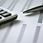 Close-up image of a financial statement with calculations and charts.